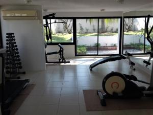 a gym with several tread machines in a room at The Sea Condominium 267/50 in Sam Roi Yot
