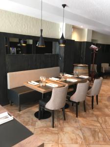 a dining room with a table and chairs at Hotel Restaurant au Floridor in Thann