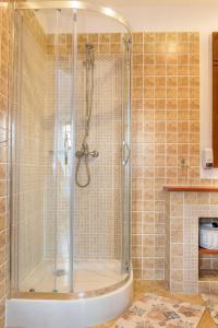 a bathroom with a shower with a tub at Apartament the Sun in Rewal