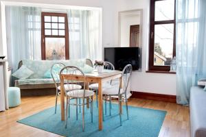 a living room with a table and chairs at Apartament the Sun in Rewal
