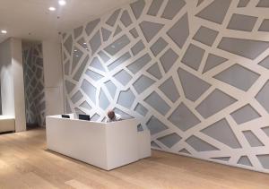 a wall with a geometric design in a room at Oַ&O Group- Luxury Apt Tower Best Sea View Bat Yam in Bat Yam