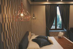 a bedroom with a bed with pillows on it at Hotel Roma Vaticano in Rome