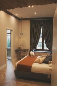 a bedroom with a bed and a desk and a window at Hotel Roma Vaticano in Rome