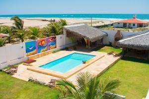 an aerial view of a house with a swimming pool and the beach at Pousada lagoa da Barra Taiba in Taíba