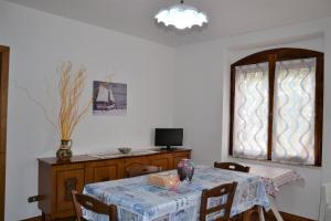 uma sala de jantar com uma mesa e uma janela em Confortevole appartamento a pochi passi dal mare em Cala Gonone