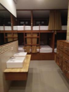 a room with bunk beds with a sink in it at Made House Homestay and Dormitory in Sanur