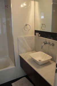 a bathroom with a sink and a mirror and a tub at Palermo nuevo - Embajada USA in Buenos Aires