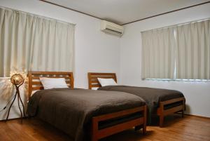 Postel nebo postele na pokoji v ubytování 女性専用 Inn By The Sea Kamakura - Women's Guesthouse