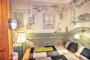 a bedroom with a bed with a drawing on the wall at Lavender Circus Hostel, Doubles & Ensuites in Budapest