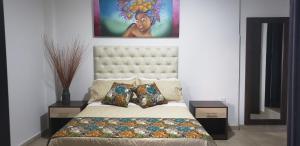 a bedroom with a bed with a large headboard at Hotel San Blass in La Unión