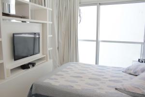 a bedroom with a bed and a tv on a wall at Palermo nuevo - Embajada USA in Buenos Aires