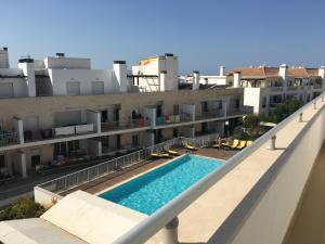 a swimming pool on the side of a building at Penthouse Ria in Santa Luzia