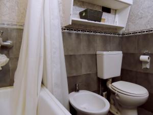 a bathroom with a toilet and a sink and a shower at Ezenahí de la Cruz del Mar in Mar del Plata +15 photos