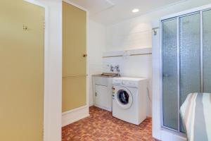 a bathroom with a washing machine and a washer at Stradbroke in Metung
