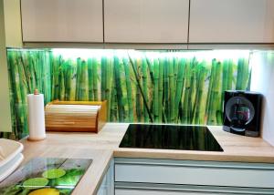 a kitchen with a green curtain with bamboo at Przytulny Apartament w Gołdapi in Gołdap
