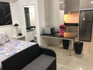 a small kitchen with a table with a microwave on it at PLAZA DE LA REPUBLICA CON GARAGE in Sao Paulo