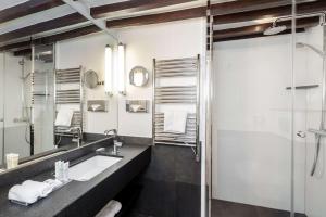a bathroom with a sink and a mirror at Best Western Plus Hotel Sydney Opera in Paris +150 photos