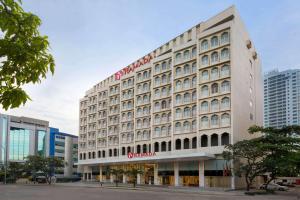 a large white building with a sign on it at Ramada Colombo in Colombo