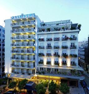 a large white building with a hotel at Poseidonio in Piraeus