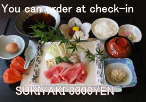 a plate of food with sushi and rice on a table at Dantokan Kikunoya in Otsu