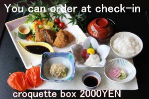 a plate of food with rice and fruits and vegetables at Dantokan Kikunoya in Otsu