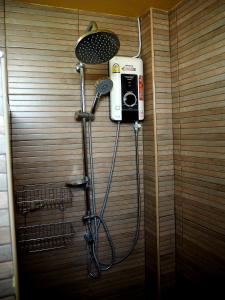 a bathroom with a shower with a hair dryer at NawiengkaeRiverview Resort in Mukdahan