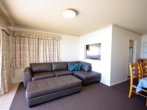 a living room with a couch and a table at Avilla Court 1 in The Entrance