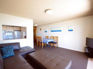 a living room with a couch and a table at Avilla Court 1 in The Entrance