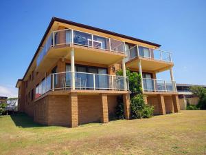 a large brick building with balconies on it at Avilla Court 1 in The Entrance