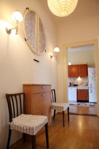 a kitchen with two chairs and a table and a mirror at Apartm&aacute;n Moyzesova in Ko&scaron;ice