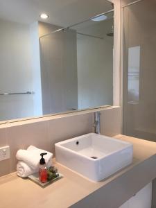 a bathroom with a white sink and a mirror at 16 Seine Bay Apartment in Augusta