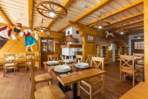 - une salle à manger avec des murs en bois, des tables et des chaises en bois dans l'établissement Relax hotel Valaška, à Horní Bečva