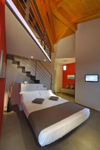 a bedroom with a large bed and a staircase at Casa Sobrero in Castiglione Falletto