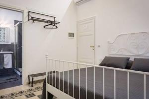 a white room with a bed and a balcony at B&B Domus Aurea in Rome