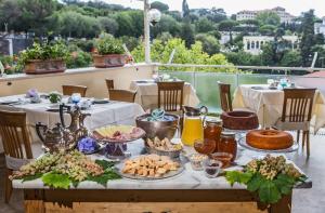 a table topped with plates of food and drinks at Hotel Cacciani in Frascati