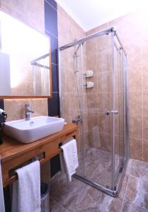 a bathroom with a shower and a sink at Marvell City Otel in Trabzon