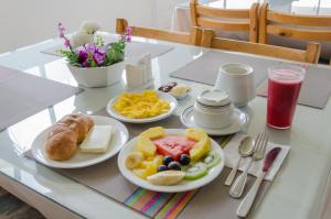 a table with plates of breakfast food on it at Hotel El Altar in Riobamba