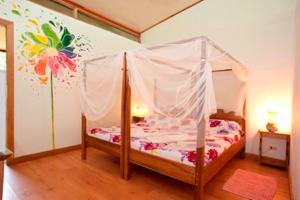 
a bed with a canopy on top of it at Blue Conga in Puerto Viejo
