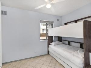 a bedroom with a bunk bed and a window at Dolphin Court 4 in The Entrance