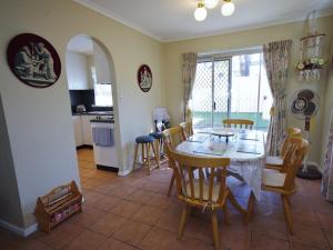 a kitchen and dining room with a table and chairs at Fravent house in Toukley