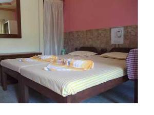 a bedroom with a large bed with towels on it at Stay at Tito's Lane in Marmagao