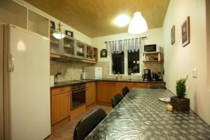 a kitchen with a table and chairs and a refrigerator at Litlabjarg Guesthouse in Hrafnabjorg +32 photos