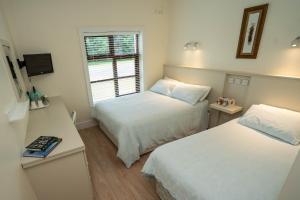 a small room with two beds and a window at Slidala B&B in Roscrea