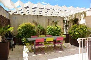 a table and chairs under a white canopy on a patio at Le Clos Millot in Beaune +11 photos