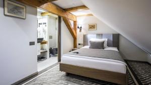 Postel nebo postele na pokoji v ubytování Michaelson Boutique Hotel & SPA Brícoła