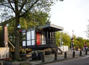 a tiny house on the side of a street at SWEETS - Theophile de Bockbrug in Amsterdam