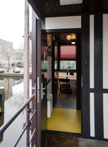 an open door of a house with a dining table at SWEETS - Theophile de Bockbrug in Amsterdam