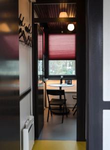 a dining room with a table and a window at SWEETS - Theophile de Bockbrug in Amsterdam