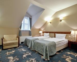 Posteľ alebo postele v izbe v ubytovaní Hotel Koronny