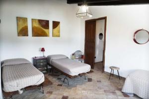 a room with two beds and a table at Agriturismo Baglio San Nicola in Naro